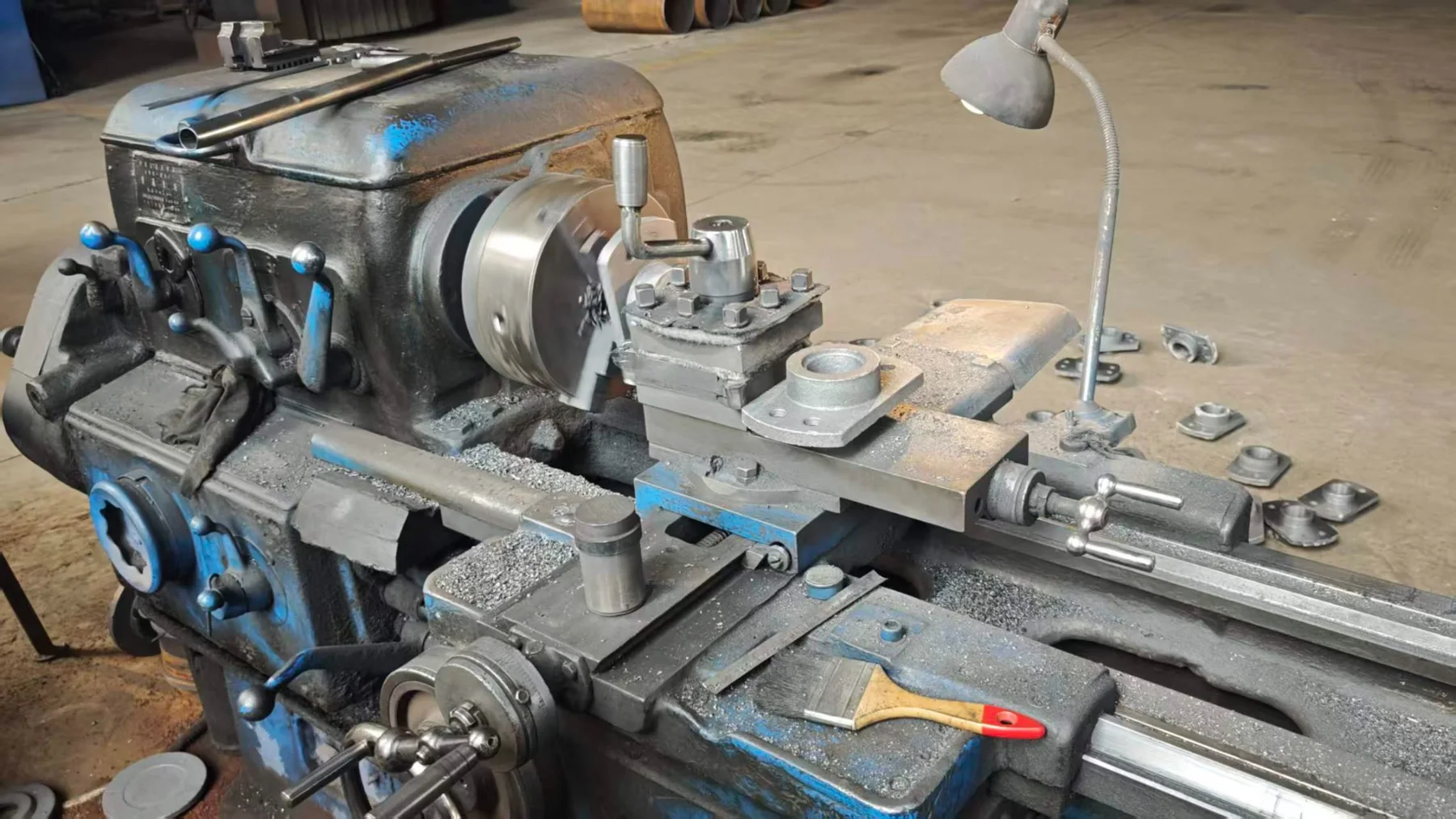 Conveyor component being turned on a workshop lathe