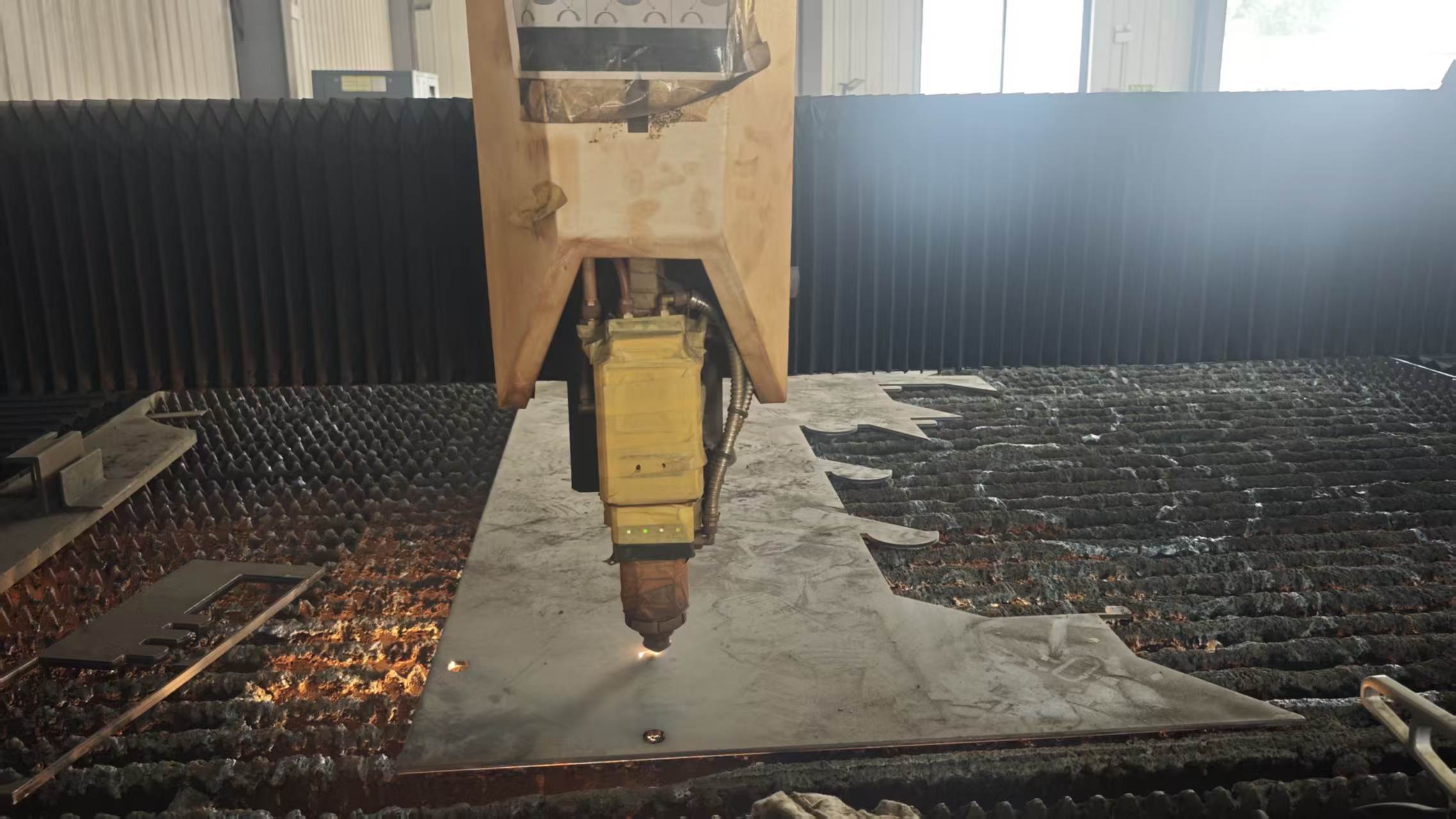 Steel plate being cut and prepared for conveyor component manufacturing