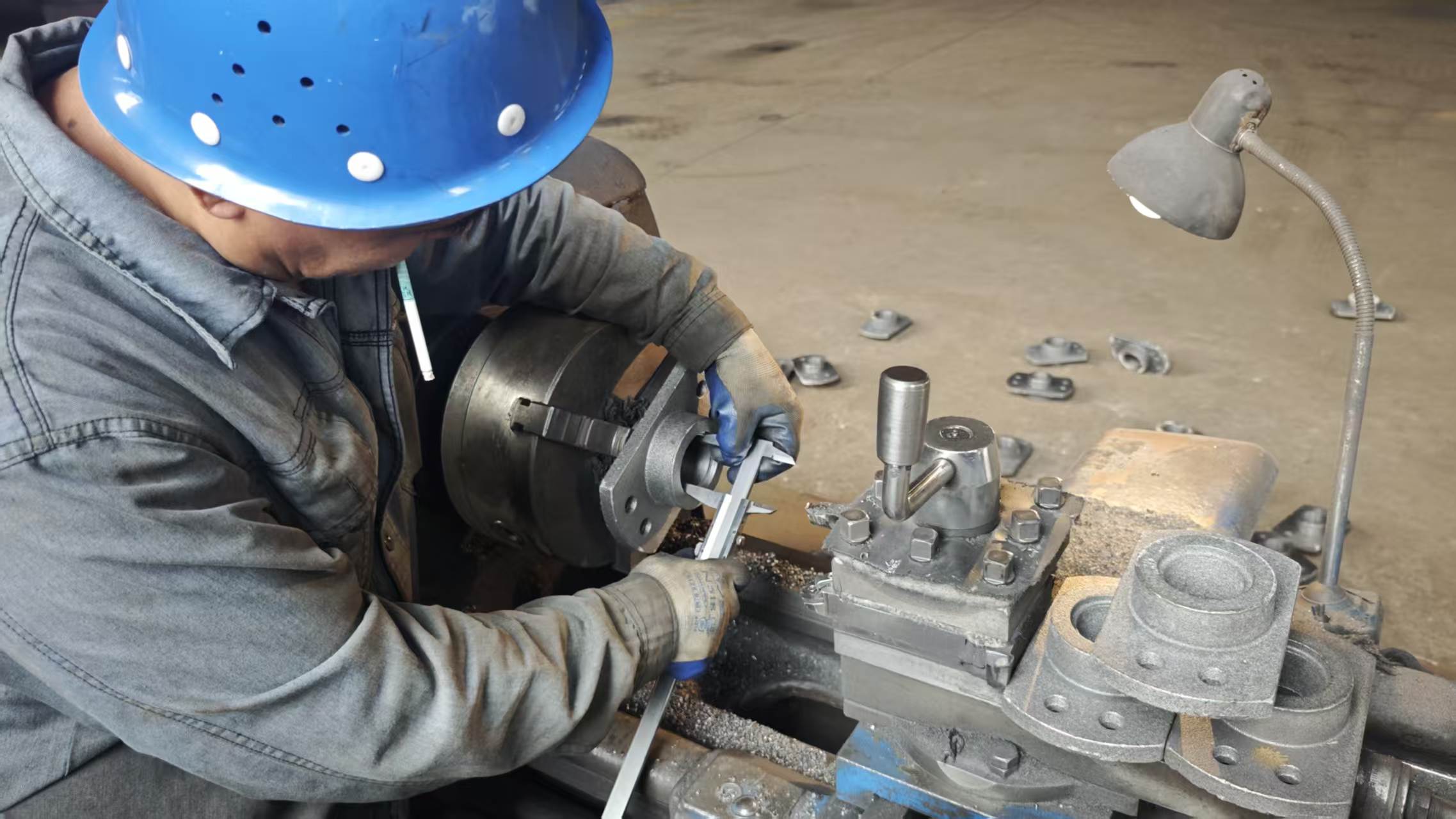 Junxin technician carrying out quality inspection on a machined conveyor component